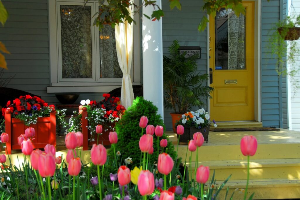 House porch in spring with wicker furniture and tulips