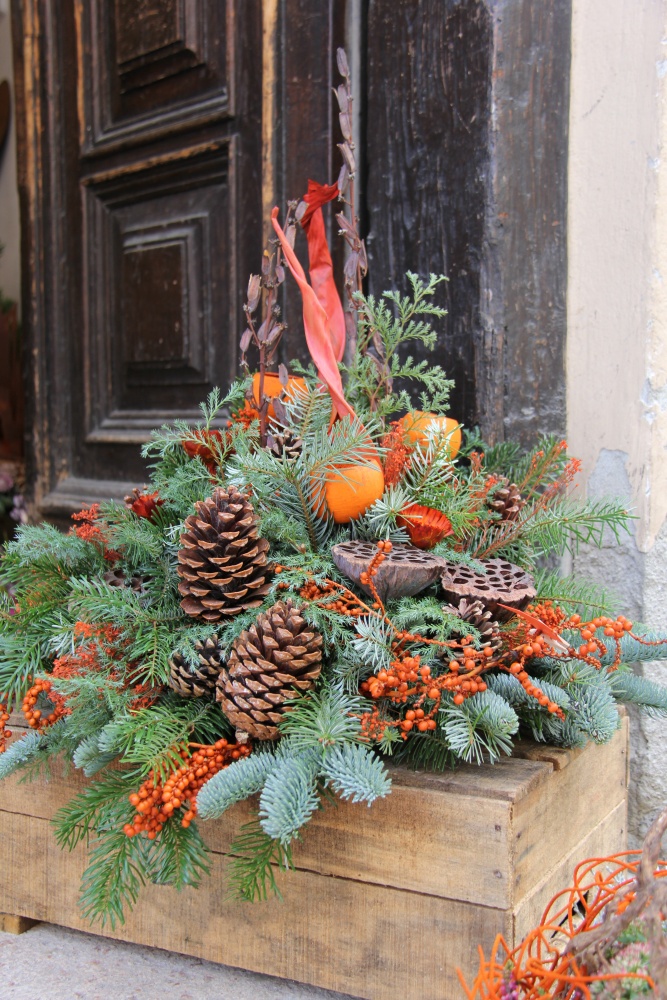 Christmas window box with evergreens and pine cones