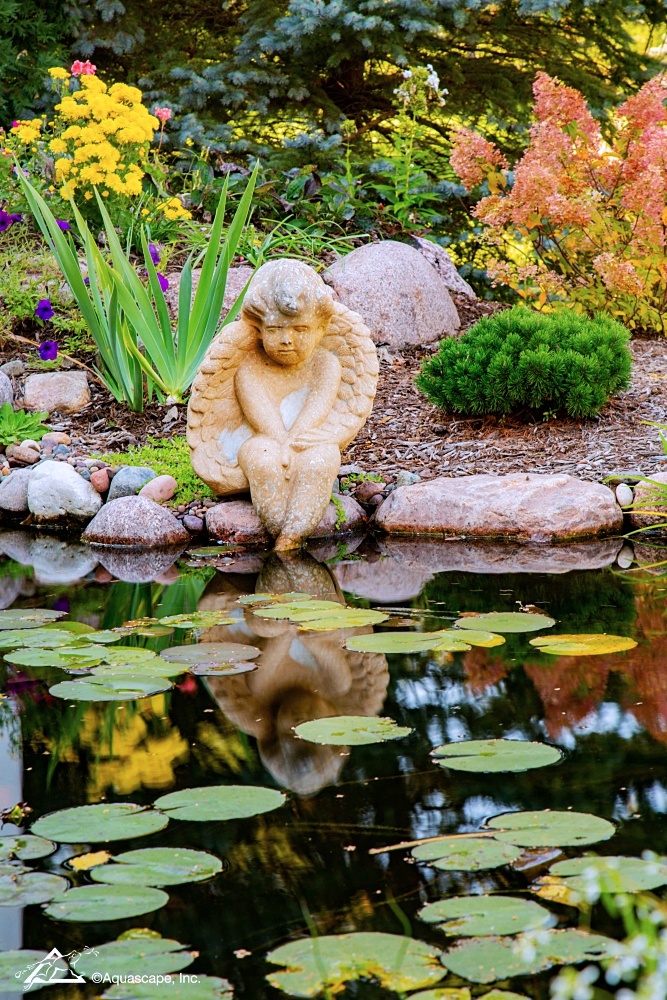 Garden angel by a garden pond