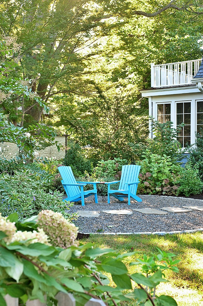 pebble patio with turquoise Adirondack chairs