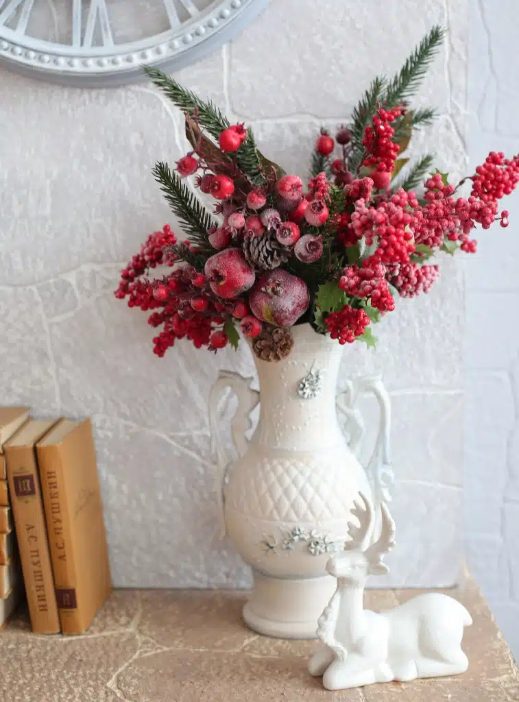 red berry arrangement in tall vase